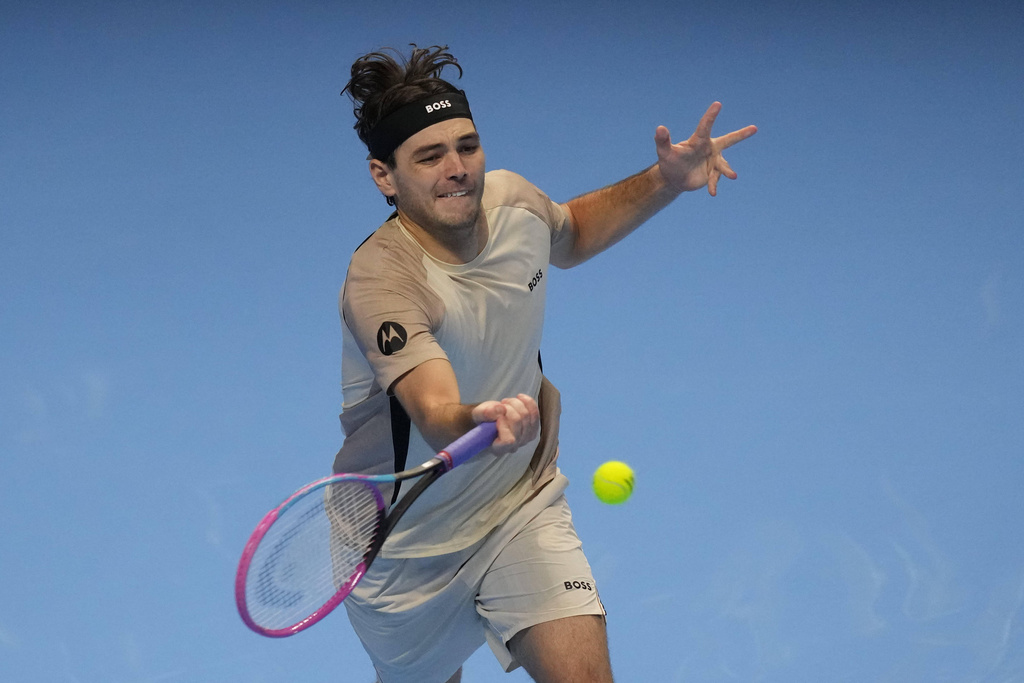 United States' Taylor Fritz returns the ball to Italy's Lorenzo Musetti during their singles tennis match of the ATP World Tour Finals, in Turin, Italy, Monday, Nov. 10, 2025. (AP Photo/Antonio Calanni)