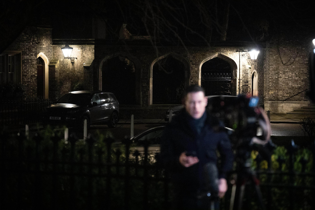Journalists gather outside the home of Lord Peter Mandelson following his arrest on suspicion of misconduct in public office, in London, Tuesday, Feb. 24, 2026. (James Manning/PA via AP)
