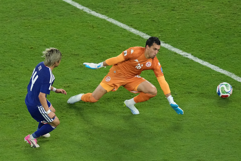 Junya Ito scores Japan's third goal past Tunisia goalkeeper Aymen Dahmen during a World Cup Group F soccer match in Guadalupe, near Monterrey, Mexico, Saturday, June 20, 2026. (AP Photo/Moises Castillo)