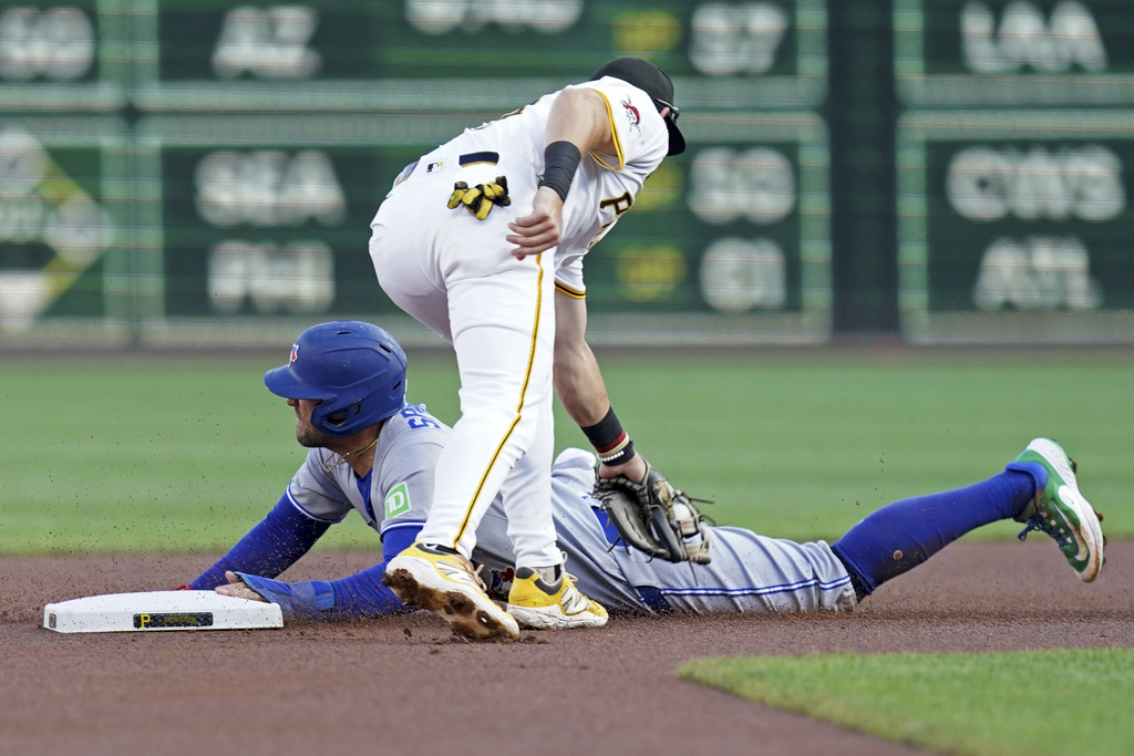 Toronto Blue Jays' George Springer, bottom, steals second as Pittsburgh Pirates shortstop Jared Triolo, top, applies the late tag during the first inning of a baseball game Tuesday, Aug. 19, 2025, in Pittsburgh. (AP Photo/Matt Freed)