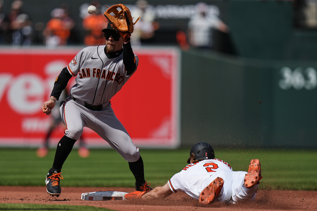 Baltimore Orioles' Gunnar Henderson (2) steals second base in front of San Francisco Giants second baseman Christian Koss, left, during the third inning of a baseball game, Sunday, April 12, 2026, in Baltimore. (AP Photo/Stephanie Scarbrough)
