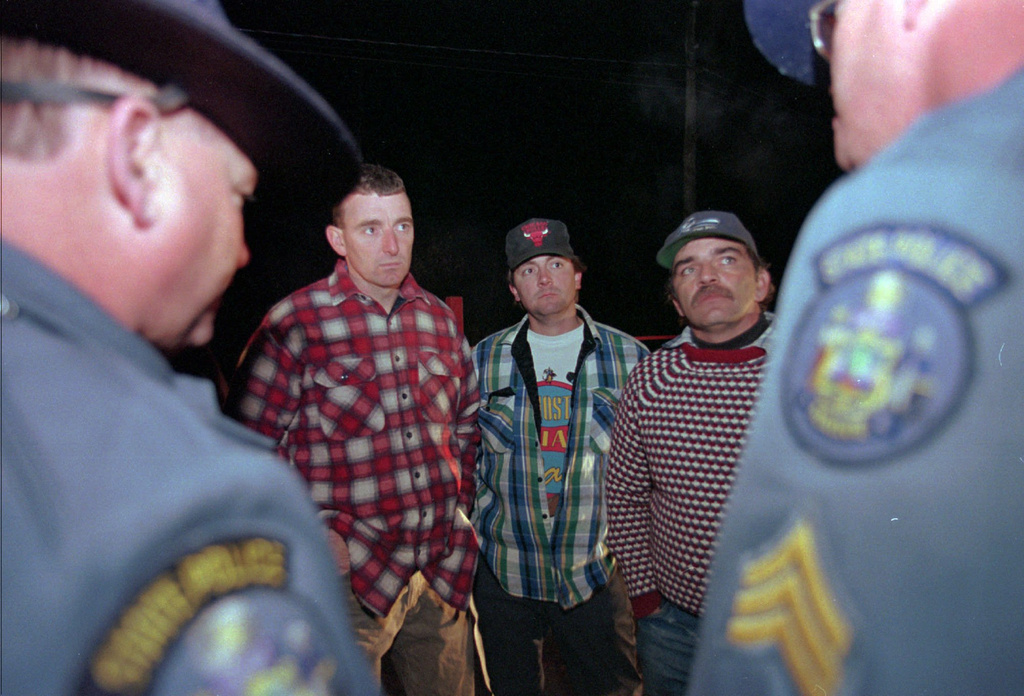 FILE - Maine loggers Stacey Kelly, second from left, Troy Jackson, and Hilton Hafford are threatened with arrest by Maine State Police if they continue to block access to Canadian woodsmen at the border at St. Pamphile, Quebec, Monday, Oct. 26, 1998. (AP Photo/Robert F. Bukaty,File)