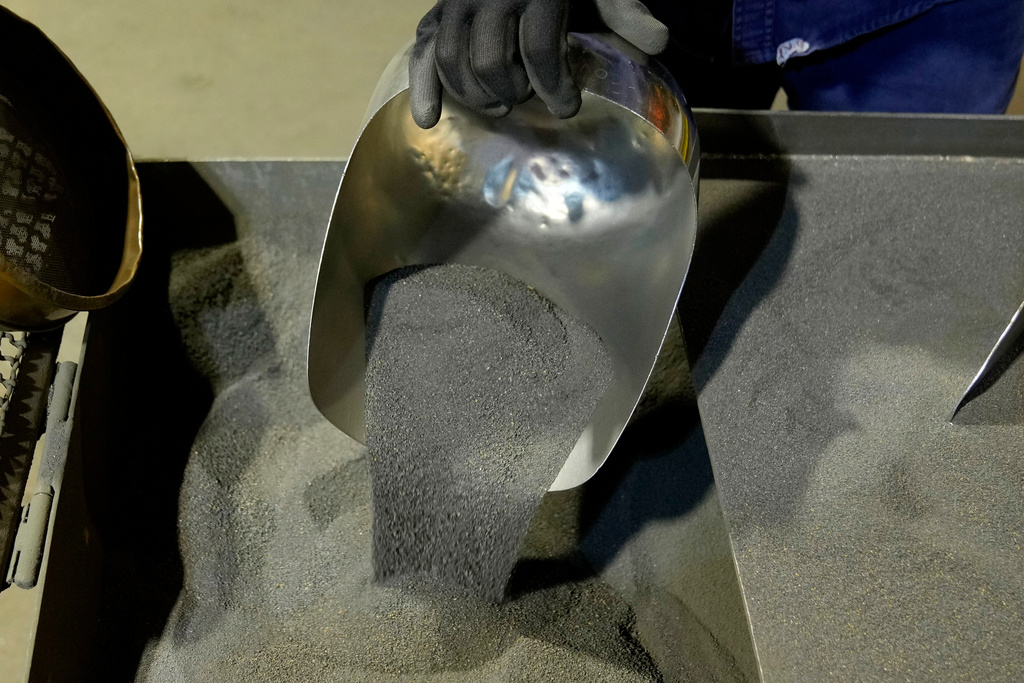 FILE - A worker shows sample of nickel matte at a processing plant in Sorowako, South Sulawesi, Indonesia, Sept. 12, 2023. (AP Photo/Dita Alangkara, File)