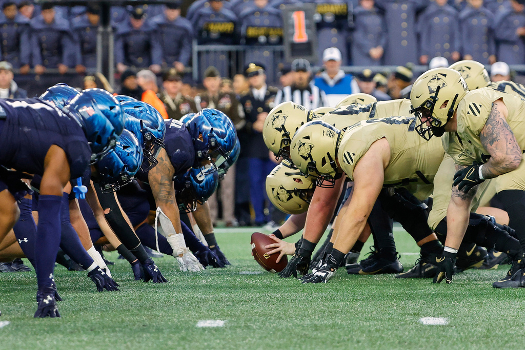 FILE - The Navy, left, and Army line up for the snap at the line of scrimmage during the first quarter of an NCAA football game at Gillette Stadium Saturday, Dec. 9, 2023, in Foxborough, Mass. (AP Photo/Winslow Townson, File)