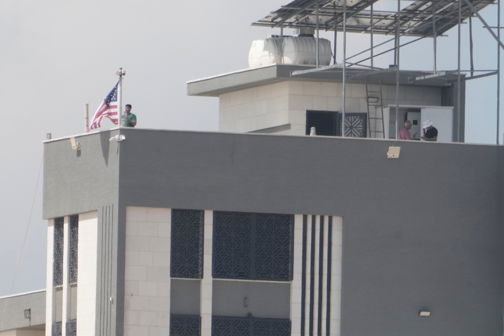 Ohio-based Palestinian-American landlord Loui Ridi, raised the American flag on the roof of his house that is besieged by Israeli settlers for over a week, in the occupied West Bank village of Qusra, south of Nablus, Tuesday, Aug. 18, 2026. (AP Photo/Majdi Mohammed)