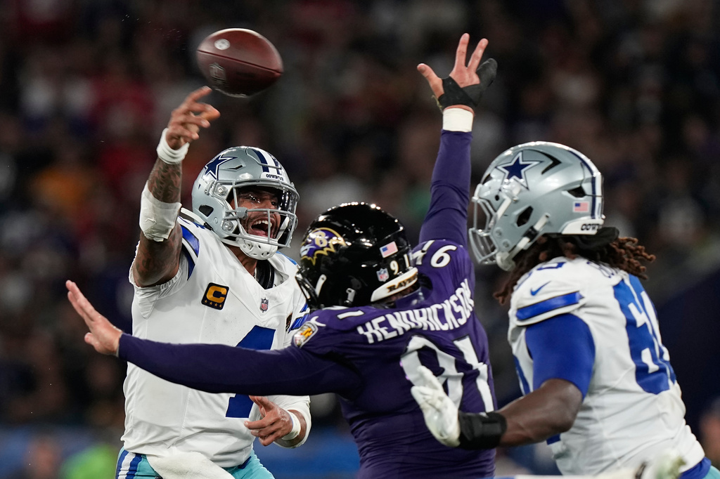 Dallas Cowboys quarterback Dak Prescott (4) throws while threatened by Baltimore Ravens linebacker Trey Hendrickson (91) during the first half of an NFL football game in Rio de Janeiro, Sunday, Sept. 27, 2026. (AP Photo/Fernando Llano)