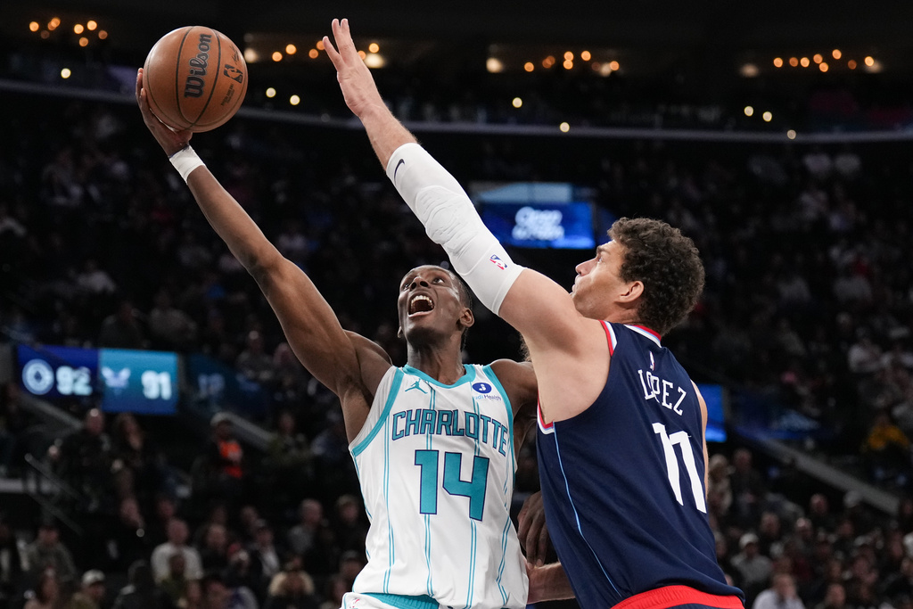 Charlotte Hornets forward Moussa Diabate (14) goes up for a basket under pressure by Los Angeles Clippers center Brook Lopez (11) during the second half of an NBA basketball game Monday, Jan. 12, 2026, in Inglewood, Calif. (AP Photo/Jae C. Hong)