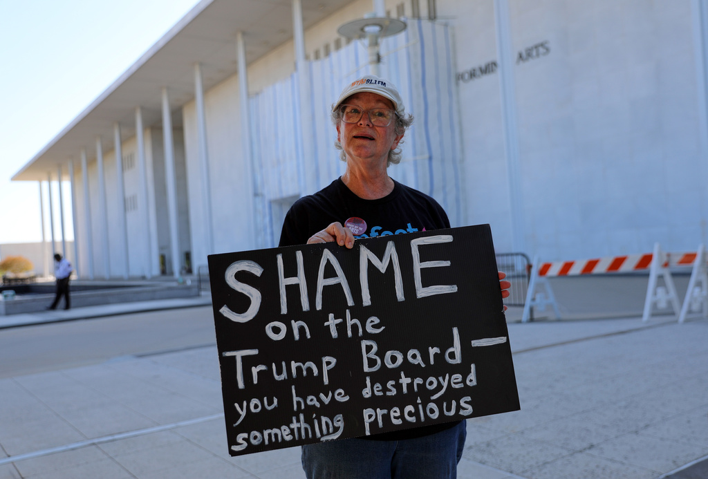 Laura Bligh of Vienna, Va., holds a protest sign outside the John F. Kennedy Center for the Performing Arts in Washington, Wednesday, Sept. 16, 2026, in Washington. (AP Photo/Rahmat Gul)
