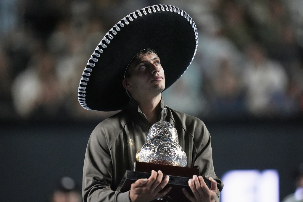 FILE - Flavio Cobolli of Italy holds the trophy after winning the men's singles final match against Frances Tiafoe of the U.S. at the Mexican Open tennis championship in Acapulco, Mexico, Feb. 28, 2026. (AP Photo/Eduardo Verdugo, File)