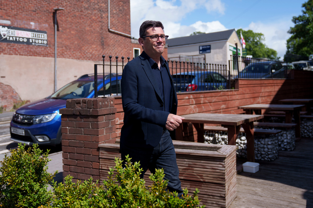 FILE - Andy Burnham walks during a campaign visit to the town of Ashton-in-Makerfield before the forthcoming Makerfield by-election, in Greater Manchester, England, Tuesday, June 9, 2026. (AP Photo/Jon Super, file)
