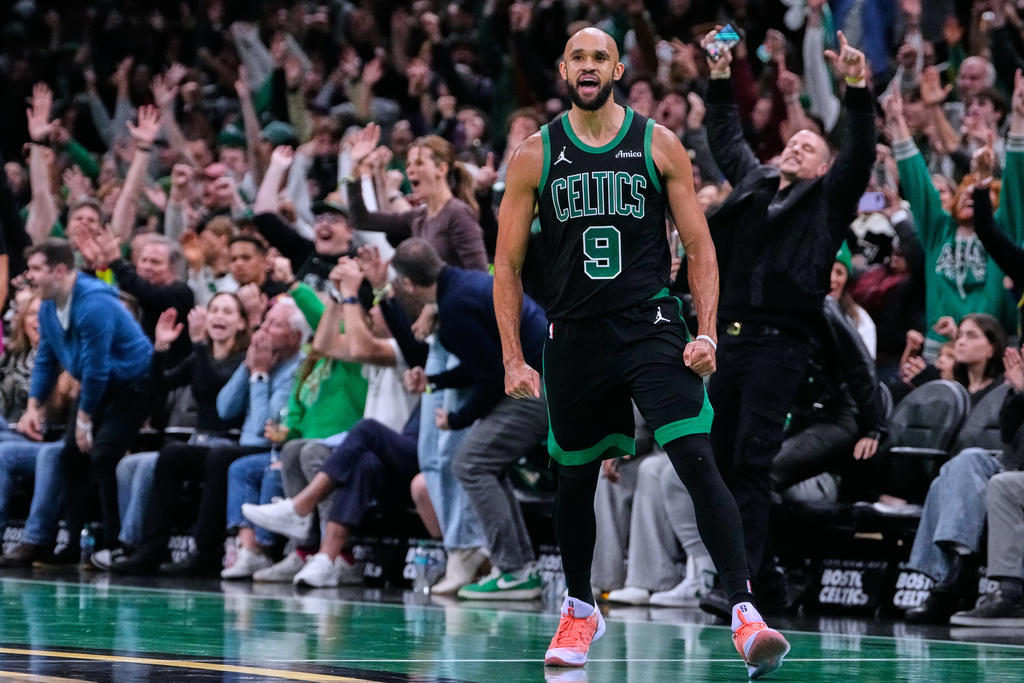 Boston Celtics guard Derrick White (9) celebrates after hitting a there-pointer late in the second half of an Emirates NBA Cup basketball game against the Detroit Pistons, Wednesday, Nov. 26, 2025, in Boston. (AP Photo/Charles Krupa)