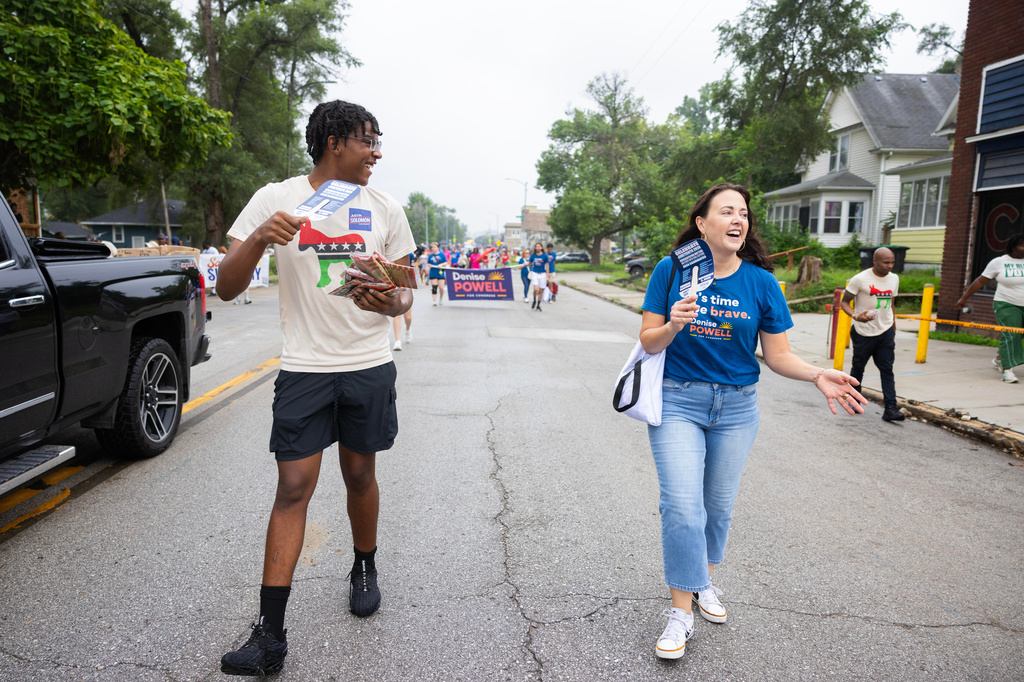 Lailend Duncan, 17, left, secretary of the Nebraska Young Democrats, chats with Denise Powell, the Democratic candidate for the House of Representatives in Nebraska's second congressional district, while walking in a Juneteenth Parade in Omaha, Neb., Saturday, Aug. 15, 2026. (AP Photo/Rebecca S. Gratz)