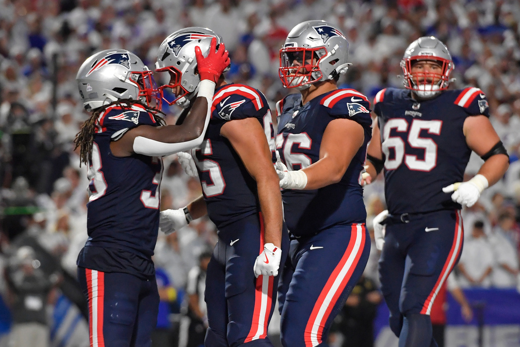 New England Patriots running back Rhamondre Stevenson, left, celebrates with teammate Hunter Henry after his touchdown against the Buffalo Bills during the second half of an NFL football game, Sunday, Sept. 5, 2025, in Orchard Park, N.Y. (AP Photo/Adrian Kraus)
