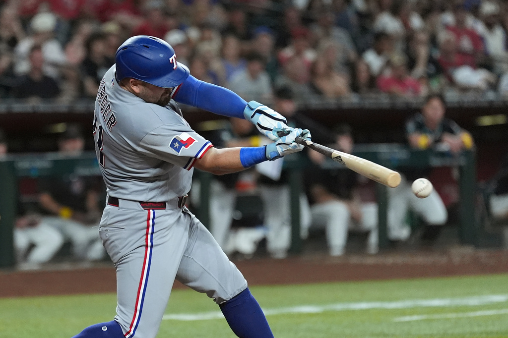Texas Rangers' Jake Burger connects for a single against the Arizona Diamondbacks during the fifth inning of a baseball game, Saturday, Sept. 12, 2026, in Phoenix. (AP Photo/Ross D. Franklin)