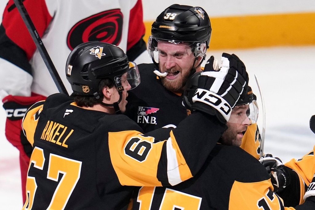 Pittsburgh Penguins' Anthony Mantha (39) celebrates his goal with Rickard Rakell (67) and Bryan Rust (17) during the first period of an NHL hockey game against the Carolina Hurricanes in Pittsburgh, Tuesday, Dec. 30, 2025. (AP Photo/Gene J. Puskar)