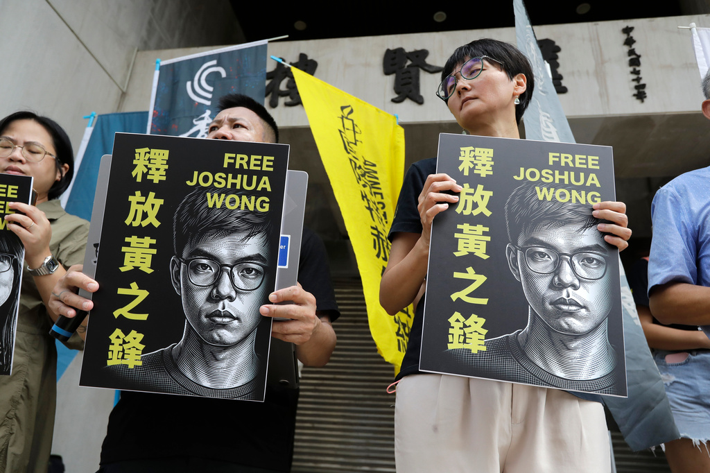 Hong Kong activist and supporters hold signs during a press event to support pro-democracy activist Joshua Wong in Taipei, Taiwan, Wednesday, Sept. 2, 2026. (AP Photo/Chiang Ying-ying)