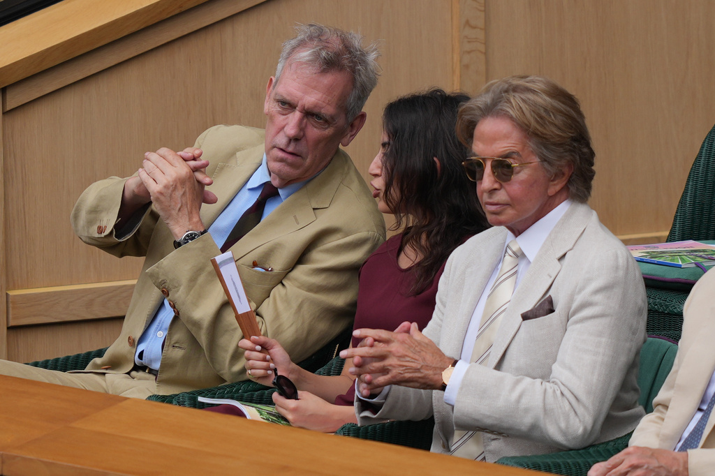 Actor Hugh Laurie, left, attends the royal box on day 12 of the Wimbledon Tennis Championships in London, Friday, July 10, 2026. (AP Photo/Kin Cheung)