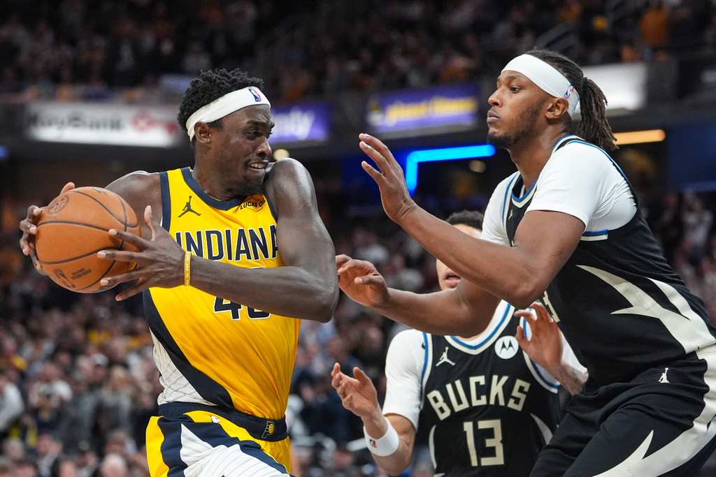 Indiana Pacers forward Pascal Siakam (43) drives on Milwaukee Bucks forward Myles Turner (3) during the second half of an NBA basketball game in Indianapolis, Monday, Nov. 3, 2025. (AP Photo/Michael Conroy)