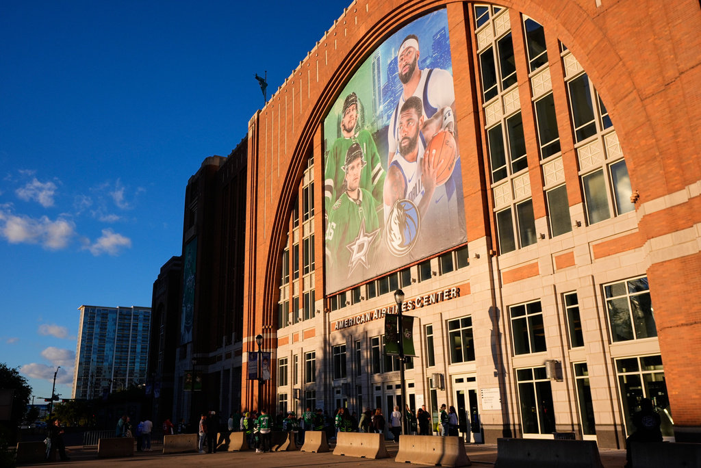 FILE - Fans line up outside the doors of American Airlines Center before the start of an NHL hockey game in Dallas, on Tuesday, Oct. 28, 2025. (AP Photo/Tony Gutierrez, File)