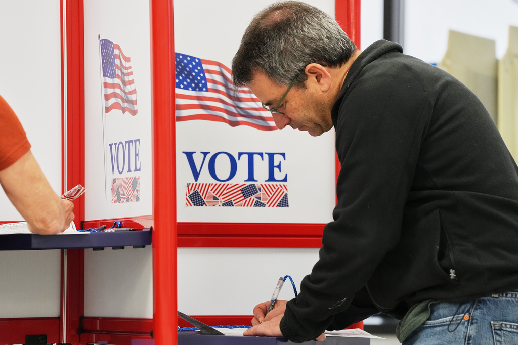 Alan Goldfarb, who said he will be out of town for the general election, casts his ballot on the first day of early voting in Minnesota at the Elections & Voter Services building, Friday, Sept. 18, 2026, in Minneapolis. (AP Photo/Ellen Schmidt)