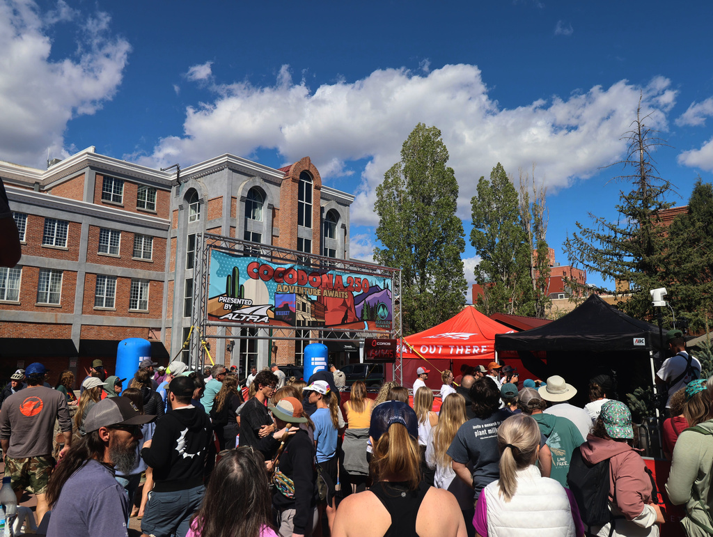 A crowd gathers to watch runners finish the Cocodona 250 ultramarathon in downtown Flagstaff, Ariz., on Wednesday, May 6, 2026. (AP Photo/Cheyanne Mumphrey)