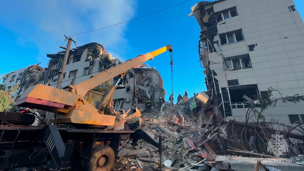 In this image taken from video released by Russian Emergency Ministry Press Service Telegram channel on Friday, May 22, 2026, Rescuers work at the side of a college dormitory building damaged by Ukrainian drones in Starobilsk, Ukraine. (Russian Emergency Ministry Press Service via AP)