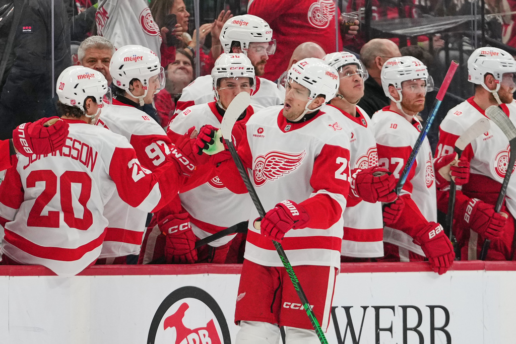 Detroit Red Wings' James van Riemsdyk (21) celebrates with teammates after scoring a goal during the second period of an NHL hockey game against the New Jersey Devils Sunday, March 8, 2026, in Newark, N.J. (AP Photo/Frank Franklin II)