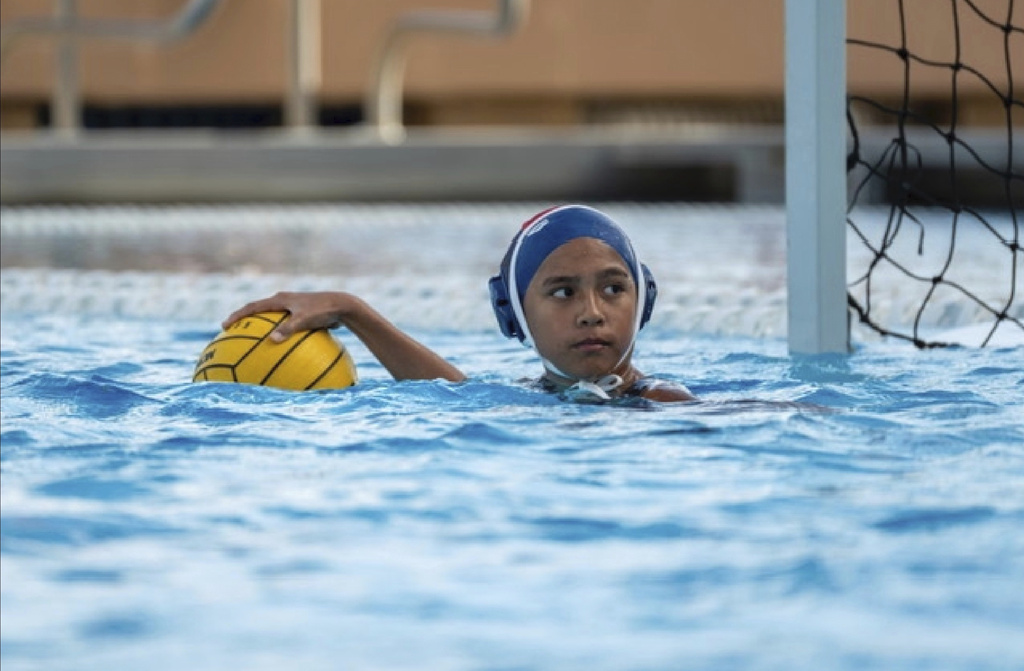 Goalie Kapua Ong controls the ball during a Kamehameha Schools water polo match on Thursday, March 28, 2024, in Honolulu. (Tiffany Canonigo-Ong via AP)
