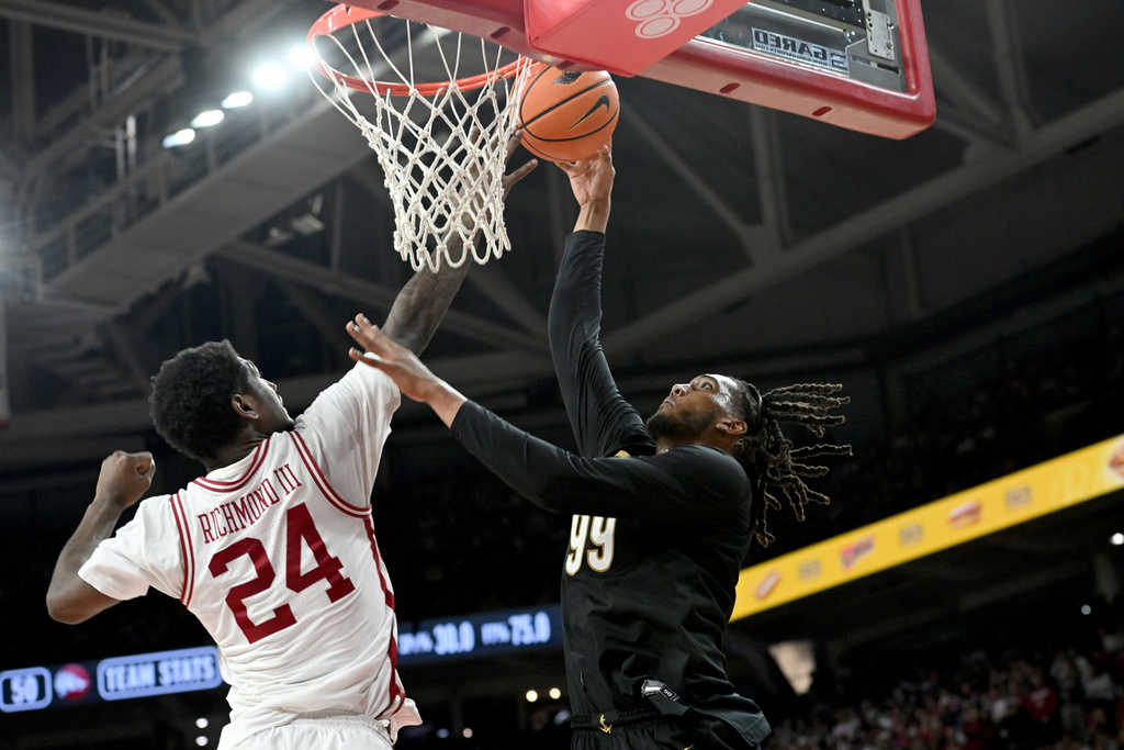 Vanderbilt forward Devin McGlockton (99) shoots over Arkansas guard Billy Richmond III (24) during the second half of an NCAA college basketball game Tuesday, Jan. 20, 2026, in Fayetteville, Ark. (AP Photo/Michael Woods)