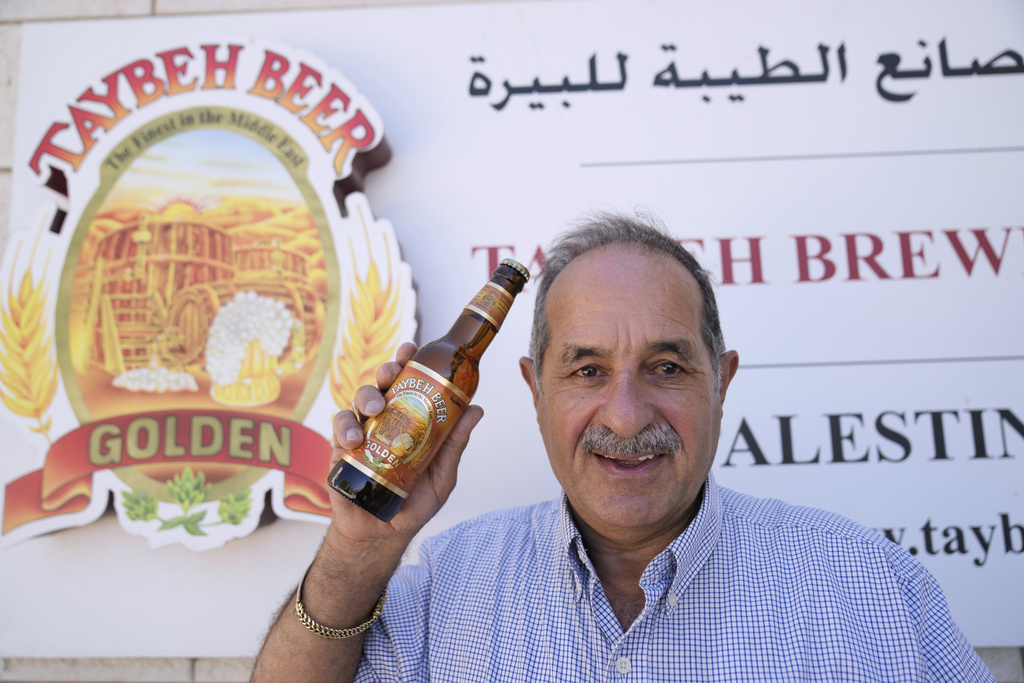 General Director Nadim Khoury shows a bottle of Taybeh beer at the family's Palestinian Taybeh Brewery Co. in the West Bank town of Taybeh, Saturday, Sept. 6, 2025. (AP Photo/Nasser Nasser)