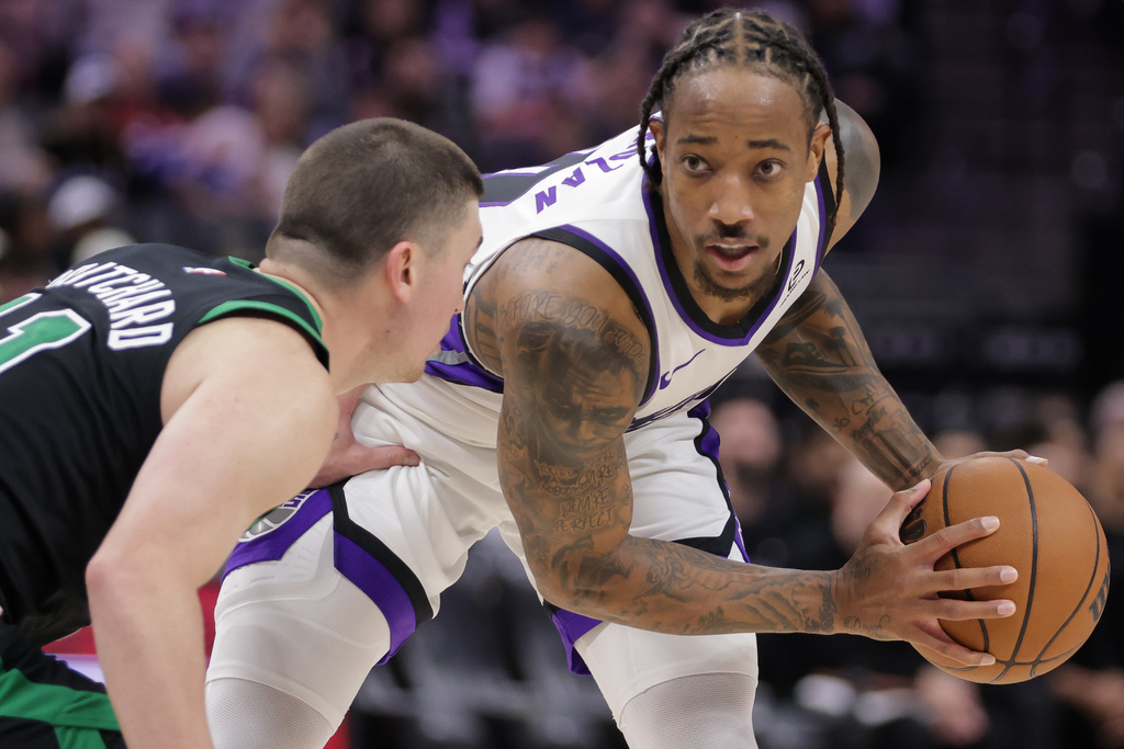 Sacramento Kings guard Demar Derozan, right, looks on while being guarded by Boston Celtics guard Payton Pritchard, left, during the second half of an NBA basketball game Thursday, Jan. 1, 2026, in Sacramento, Calif. (AP Photo/Scott Marshall)