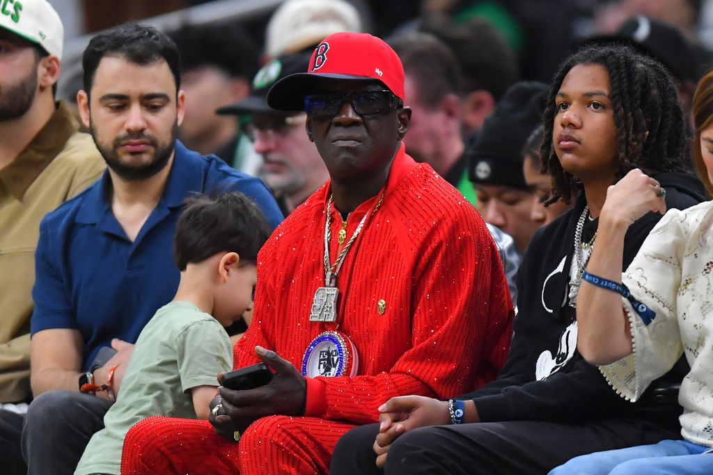 Rapper Flavor Flav, center, attends an NBA basketball game between Toronto Raptors and the Boston Celtics, Sunday, April 5, 2026, in Boston. (AP Photo/Steven Senne)