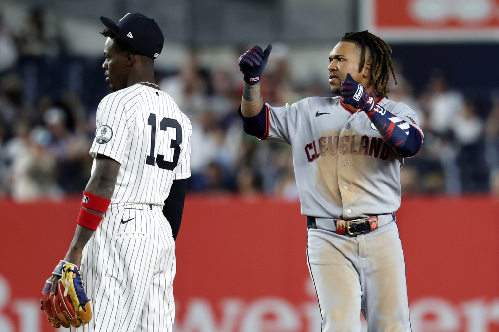 Cleveland Guardians' José Ramírez reacts after hitting a run scoring double behind New York Yankees second baseman Jazz Chisholm Jr. (13) during the seventh inning of a baseball game Tuesday, June 2, 2026, in New York. (AP Photo/Adam Hunger)