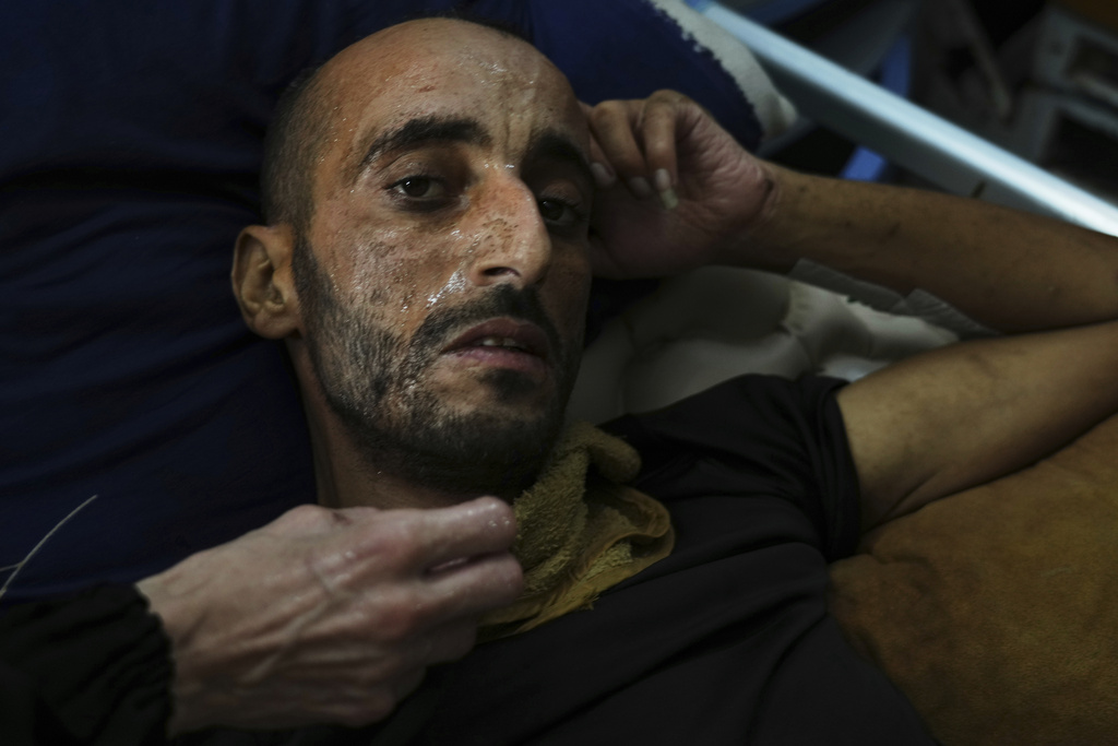 A Palestinian patient sweats during a heat wave, inside a warehouse set up in the yard of Shifa Hospital in Gaza City where there is no air conditioning, Wednesday, Aug. 13, 2025. (AP Photo/Jehad Alshrafi)