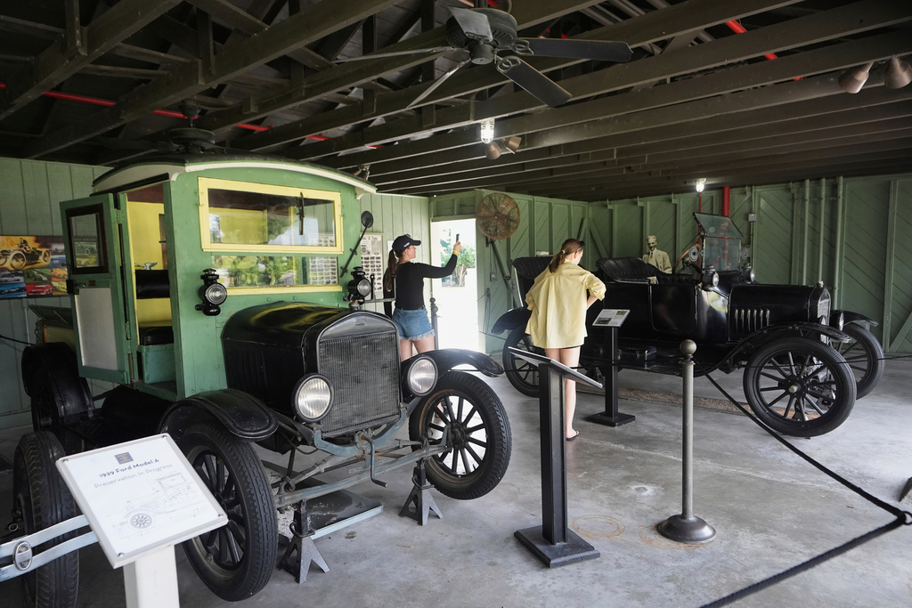 Visitors view Ford vehicles designed by Henry Ford at the Edison and Ford Winter Estates, Saturday, Aug. 9, 2025, in Fort Myers, Fla. Edison's friend, Henry Ford, purchased the adjoining property in 1916. (AP Photo/Lynne Sladky)