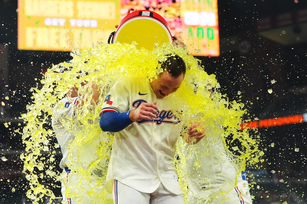 Texas Rangers' Wyatt Langford is doused after hitting the winning single in the ninth inning of a baseball game against the Los Angeles Angels, Thursday, July 9, 2026, in Arlington, Texas. (AP Photo/LM Otero)