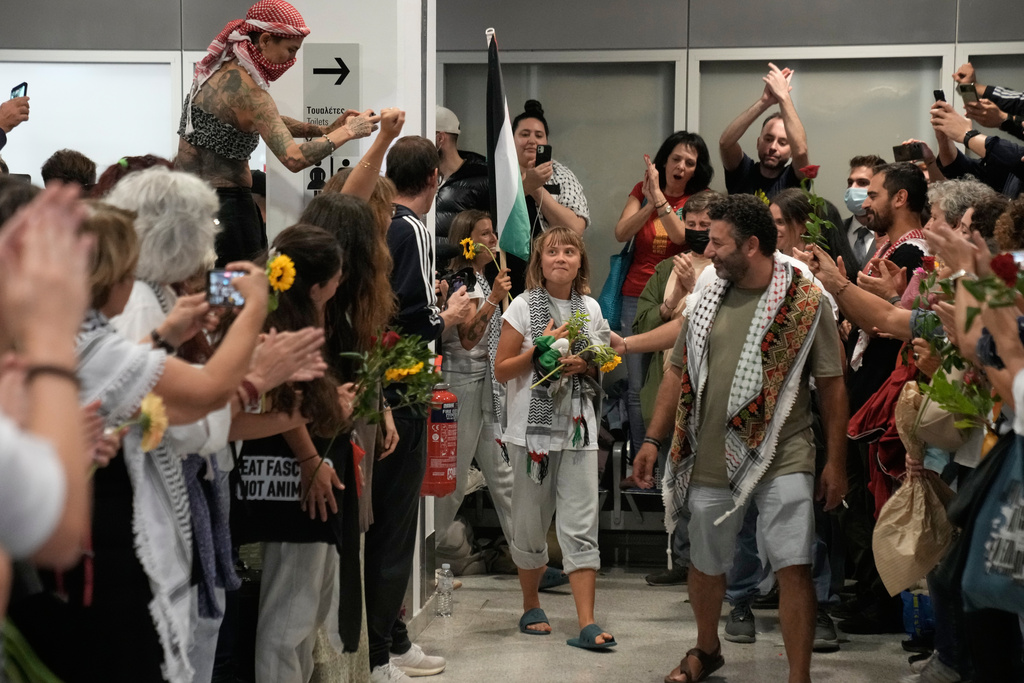 Swedish activist Greta Thunberg, center, arrives at the Eleftherios Venizelos International Airport in Athens, Monday, Oct. 6, 2025 after being deported from Israel for taking part in a Gaza-bound aid flottila. (AP Photo/Petros Giannakouris)