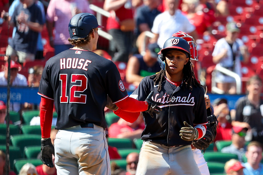 Washington Nationals' Brady House (12) congratulates CJ Abrams, right, after Abrams' two-run home run during the sixth inning of a baseball game against the St. Louis Cardinals, Sunday, Sept. 20, 2026, in St. Louis. (AP Photo/Scott Kane)