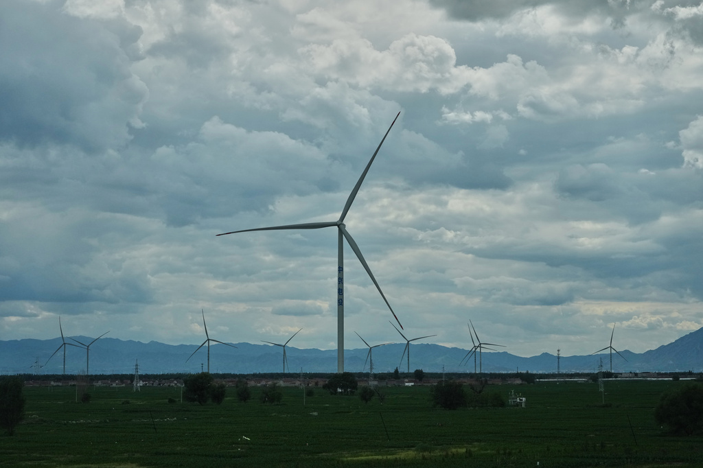 Wind turbines operate along a high speed railway line near Zhangjiakou in northern China's Hebei province on Wednesday, June 10, 2026. (AP Photo/Ng Han Guan)