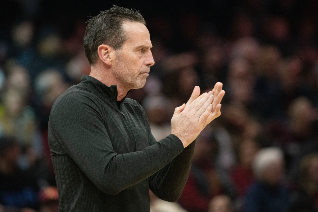 Cleveland Cavaliers head coach Kenny Atkinson applauds his team during the first half of an NBA basketball game against the Golden State Warriors in Cleveland, Saturday, Dec. 6, 2025. (AP Photo/Phil Long)