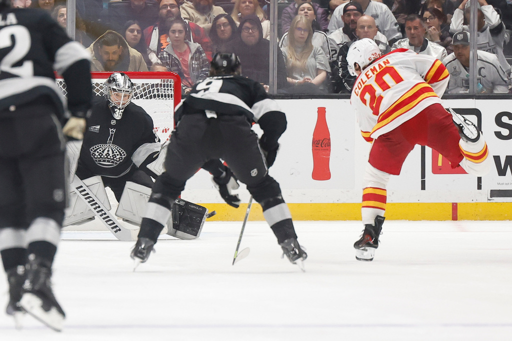 Calgary Flames left wing Blake Coleman (20) takes a shot and scores during the second period of an NHL hockey game Saturday, Dec. 13, 2025, in Los Angeles. (AP Photo/Caroline Brehman)
