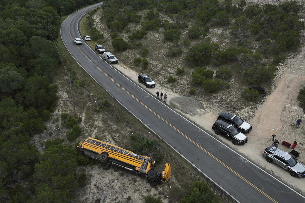 Police respond after a Leander Independent School District bus carrying students rollover crashed in Leander, Texas, Wednesday, Aug. 13, 2025. (Jay Janner/Austin American-Statesman via AP)