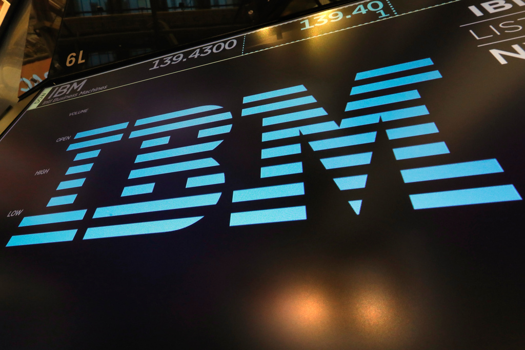 FILE - The logo for IBM appears above a trading post on the floor of the New York Stock Exchange, March 18, 2019. (AP Photo/Richard Drew, File)