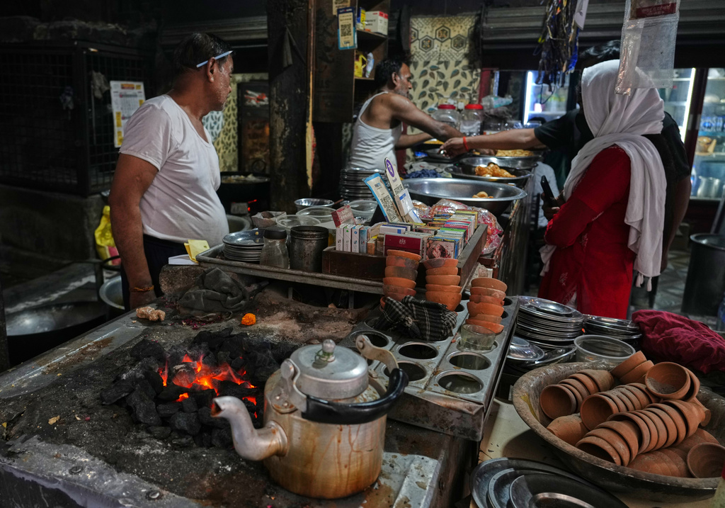 Workers cook over a coal fire at a small restaurant due to a shortage of commercial gas in Prayagraj, India, Friday, April 24, 2026. (AP Photo/Rajesh Kumar Singh)