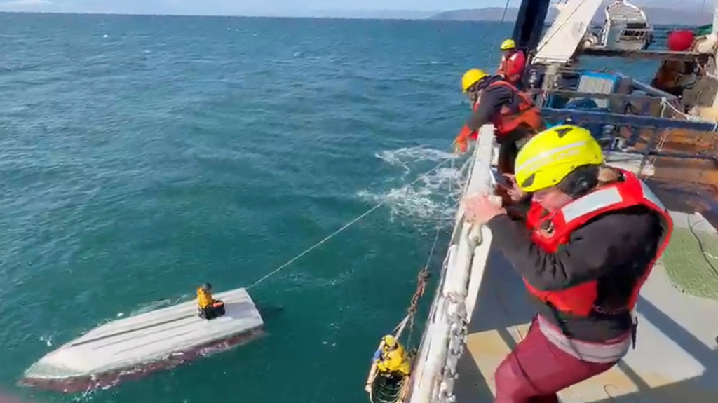 This image taken from video provided by Carlos Alexis Escartin shows a teenager being rescued by a fishing vessel Monday, Sept. 7, 2026, in the Bering Sea near St. Lawrence Island, Alaska. (Carlos Alexis Escartin via AP)