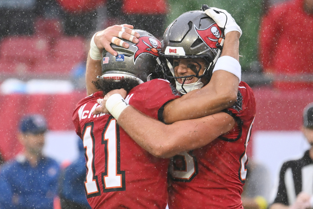 Tampa Bay Buccaneers tight end Cade Otton (88) celebrates his touchdown catch with wide receiver Jalen McMillan (11) during the first half of an NFL football game against the Carolina Panthers Saturday, Jan. 3, 2026, in Tampa, Fla. (AP Photo/Jason Behnken)