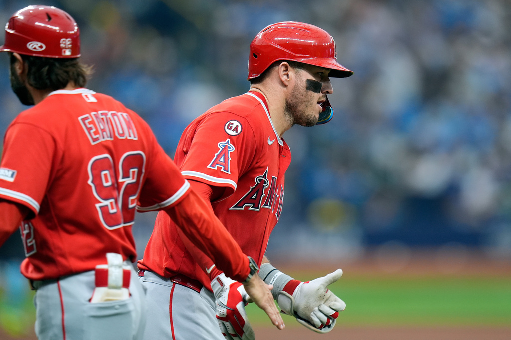 Los Angeles Angels' Mike Trout celebrates his solo home run off Tampa Bay Rays pitcher Casey Legumina with first base coach Adam Eaton (92) during the fifth inning of a baseball game Saturday, May 30, 2026, in St. Petersburg, Fla. (AP Photo/Chris O'Meara)