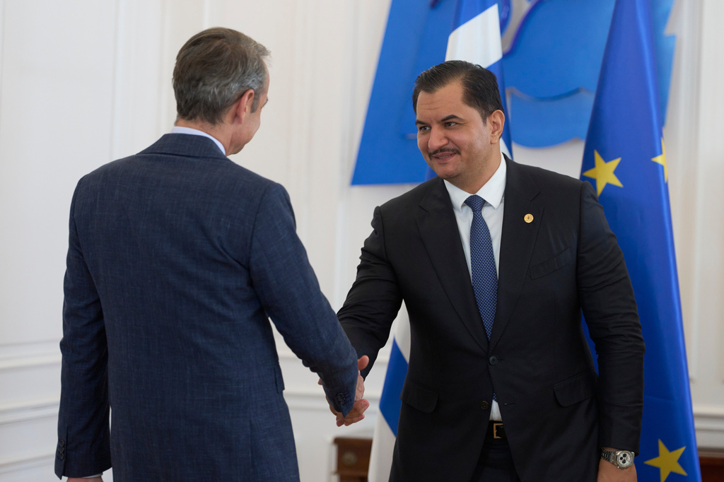 Deputy Commander of the Libyan National Army, Lieutenant General Saddam Haftar right, shakes hands with Greece's Prime Minister Kyriakos Mitsotakis, in Athens, on Monday, June 15, 2026. (AP Photo/Petros Giannakouris)