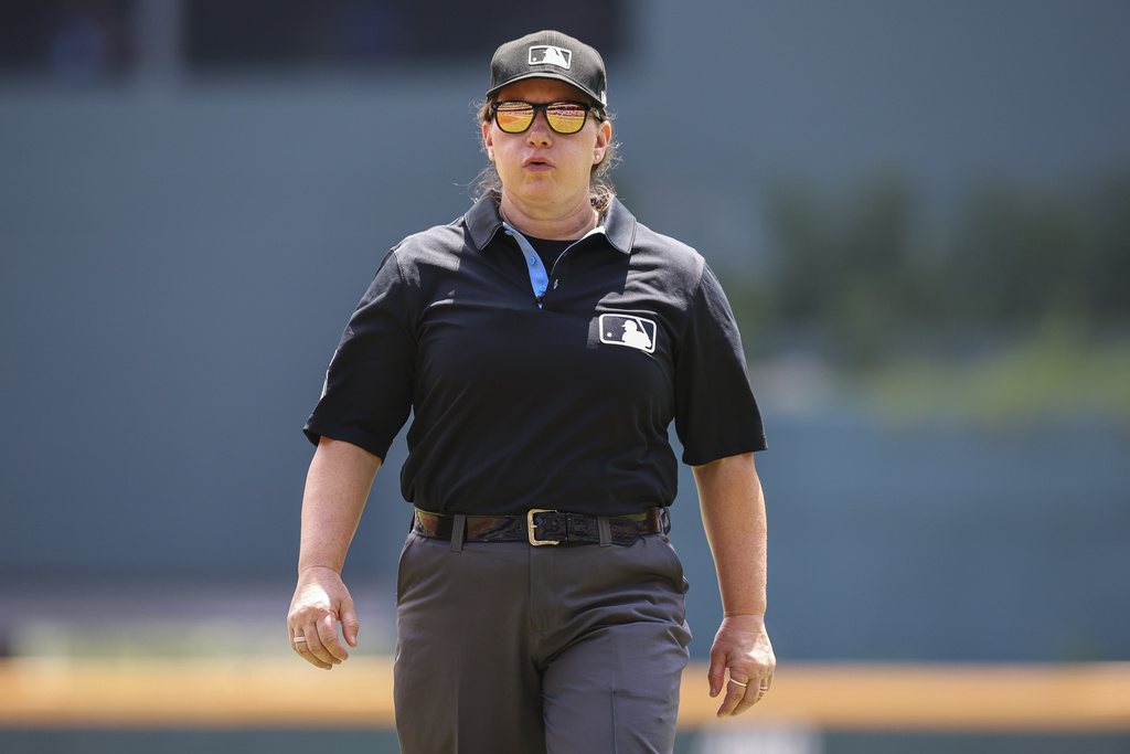 Umpire Jen Pawol, looks on during the first inning of a baseball game of a doubleheader between the Atlanta Braves and Miami Marlins, Saturday, Aug. 9, 2025, in Atlanta. (AP Photo/Colin Hubbard)