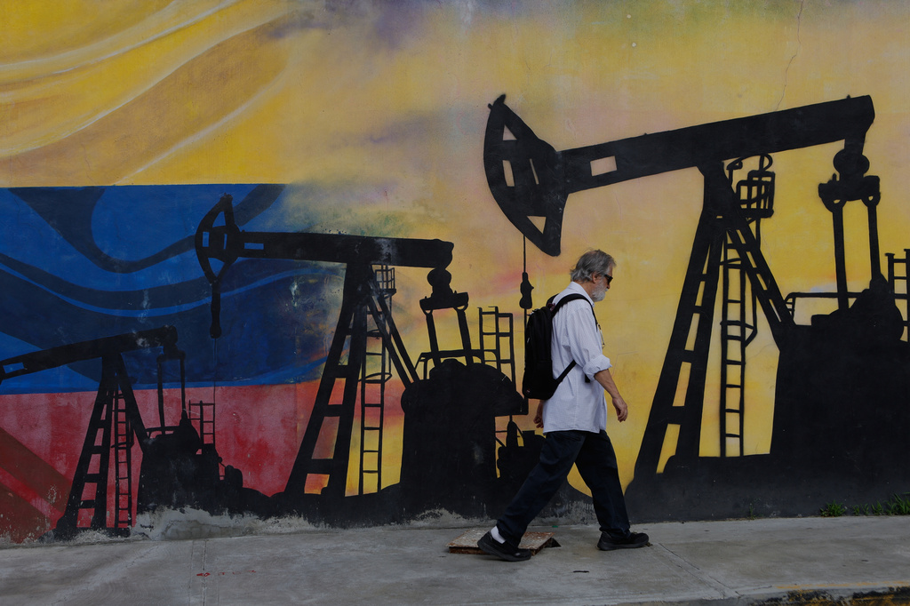 A pedestrian walks past a mural featuring oil wells in Caracas, Venezuela, Saturday, Aug 29, 2026, a day after President Donald Trump announced a deal giving the United States a stake in Venezuela’s oil reserves. (AP Photo/Pedro Mattey)